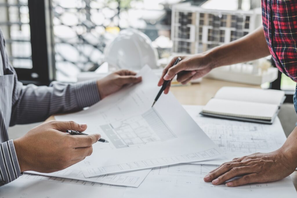 hands of architect or engineer working on blueprint meeting for
